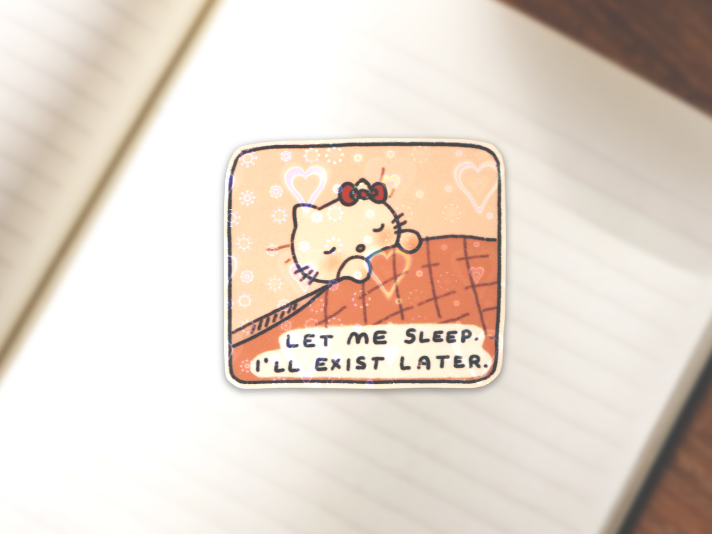 Cartoon Hello Kitty sleeping, tucked in dark pink sheets on a light pink bed sticker. Text reads 'LET ME SLEEP. I'LL EXIST LATER.'  Subtle holographic hearts lamination shown on the sticker.
